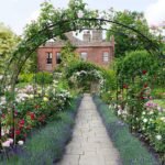 round arch with flowers and obelisks growing around